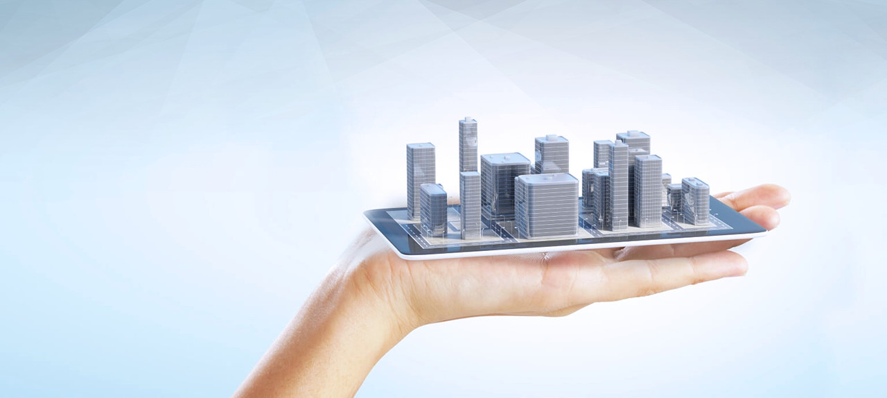 A model city resting on a tablet in an open hand